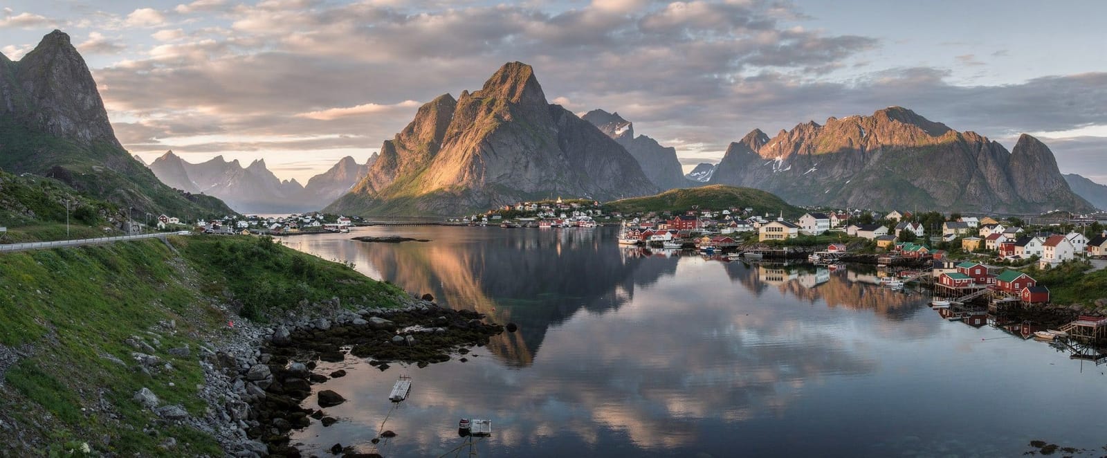 Jagged peaks rising above the fishing village of Reine at dusk